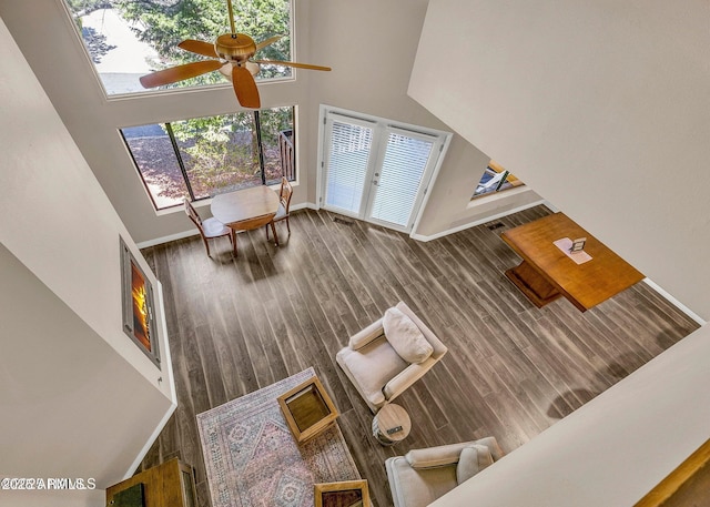 2800 N Saddleback Way Unit 2, Flagstaff, AZ 86004 - living room featuring wood finished floors, ceiling fan, a high ceiling, and plenty of natural light