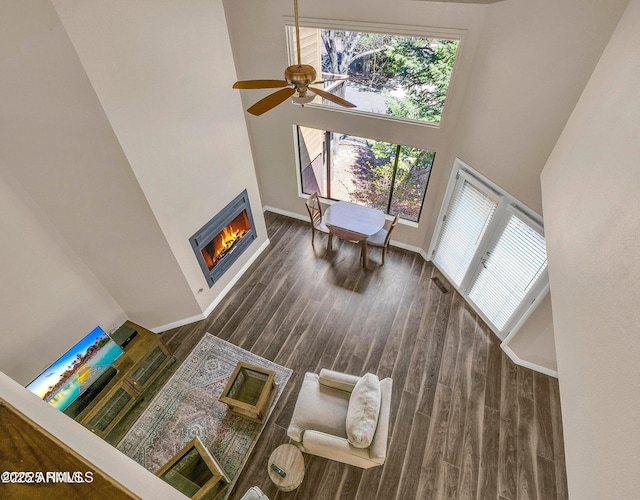 2800 N Saddleback Way Unit 2, Flagstaff, AZ 86004 - living area featuring ceiling fan, a lit fireplace, baseboards, wood finished floors, and a high ceiling