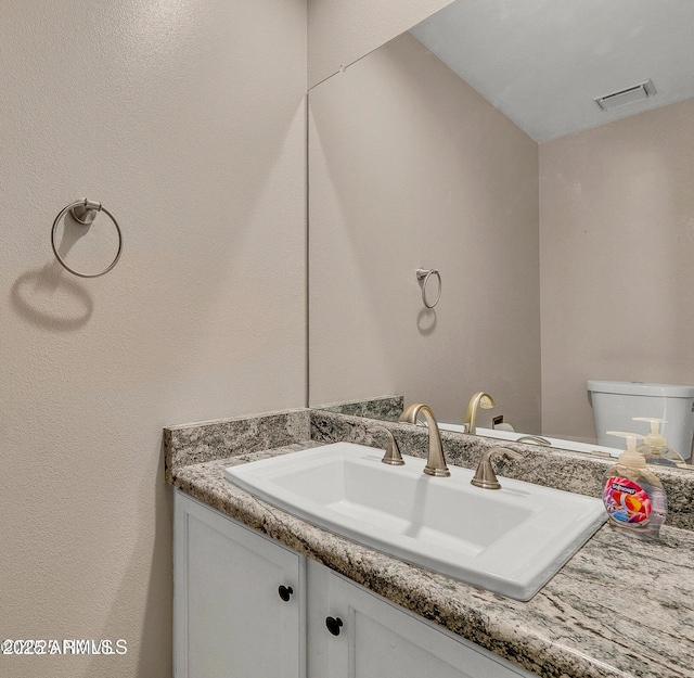 2800 N Saddleback Way Unit 2, Flagstaff, AZ 86004 - bathroom with toilet, visible vents, and vanity