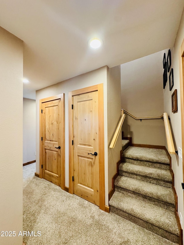 stairs with carpet flooring and baseboards