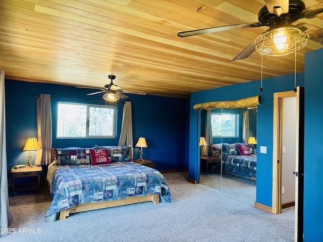 bedroom with wooden ceiling, carpet flooring, a ceiling fan, and baseboards