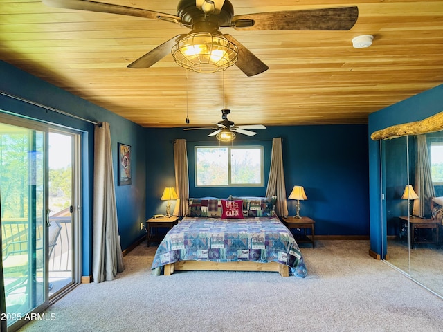 carpeted bedroom featuring multiple windows, wood ceiling, and access to outside