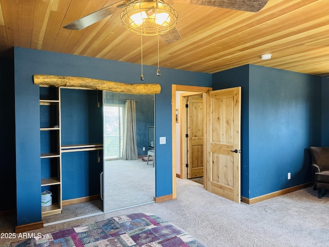 unfurnished bedroom with wooden ceiling, carpet, and baseboards