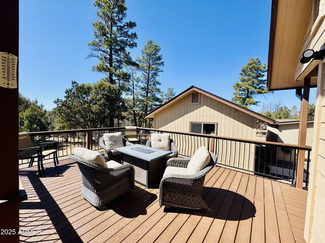 wooden terrace with an outdoor hangout area