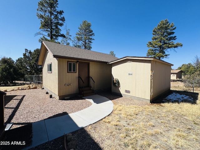 view of outdoor structure with an outbuilding and fence