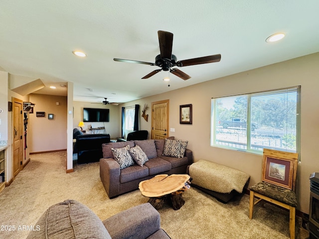 living area with recessed lighting, baseboards, light carpet, and a ceiling fan