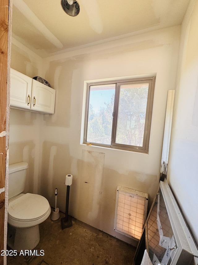 bathroom featuring radiator and toilet