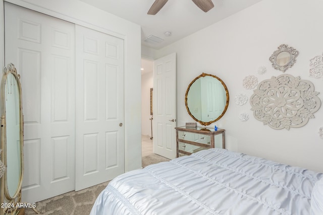 carpeted bedroom featuring a closet and ceiling fan