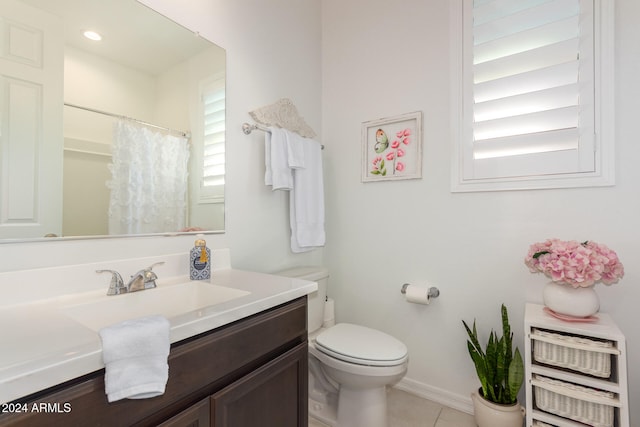 bathroom with tile patterned flooring, curtained shower, vanity, and toilet