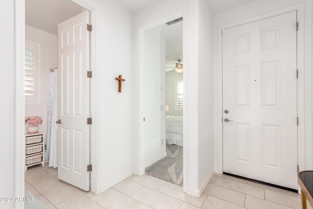 hallway featuring light tile patterned floors