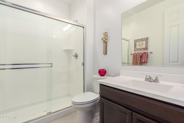 bathroom featuring tile patterned flooring, an enclosed shower, vanity, and toilet