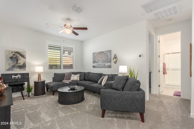 carpeted living room featuring ceiling fan