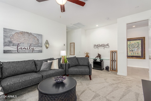 carpeted living room with ceiling fan