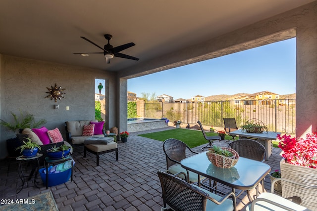 view of patio featuring ceiling fan and a swimming pool with hot tub