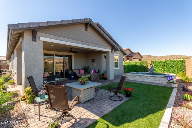 back of house with a lawn, ceiling fan, and a patio