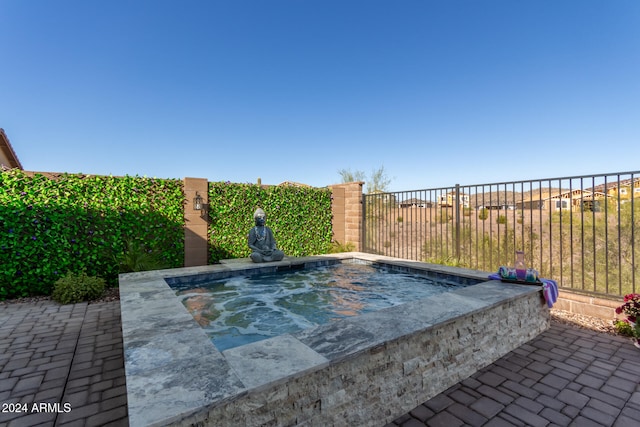 view of pool with an in ground hot tub