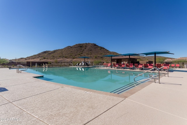 view of pool featuring a mountain view and a patio area