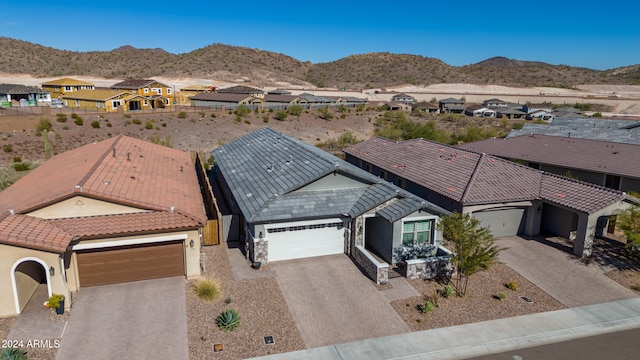 birds eye view of property with a mountain view