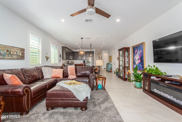 living room featuring ceiling fan and light tile patterned flooring