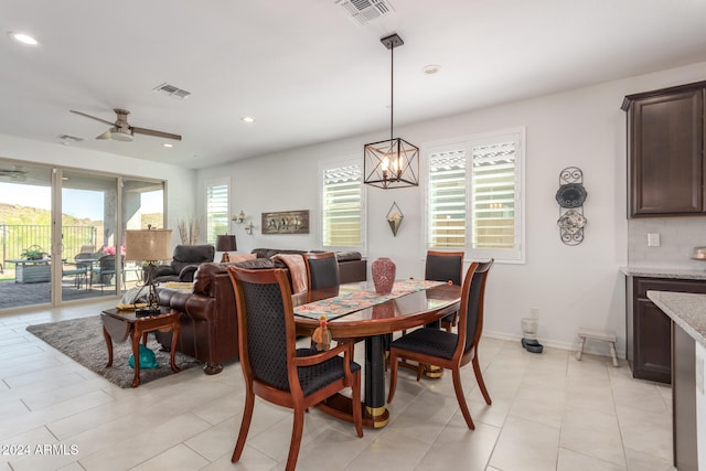 tiled dining area with ceiling fan