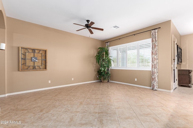 unfurnished room with light tile patterned floors and ceiling fan