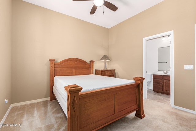 carpeted bedroom with ceiling fan and ensuite bathroom