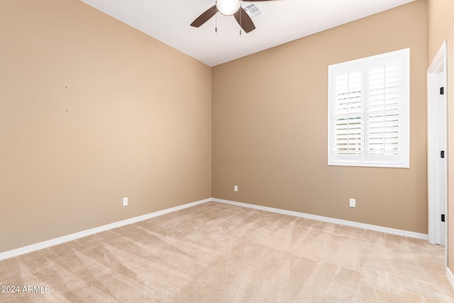 carpeted spare room featuring ceiling fan