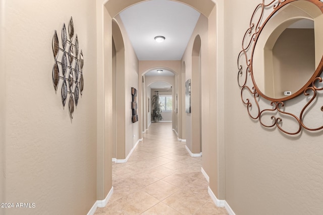 hall with tile patterned floors