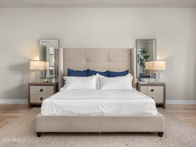 bedroom featuring light wood-style flooring and baseboards