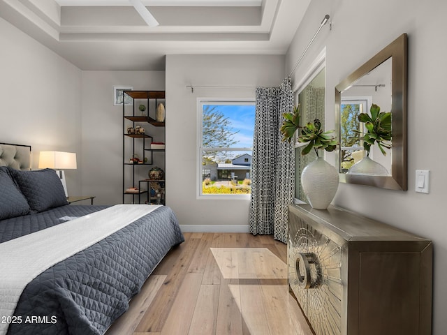 bedroom featuring light wood-style floors and baseboards