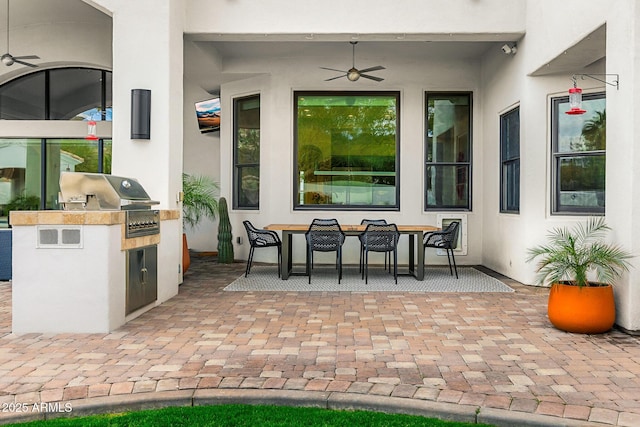 view of patio featuring a ceiling fan, outdoor dining area, grilling area, and area for grilling