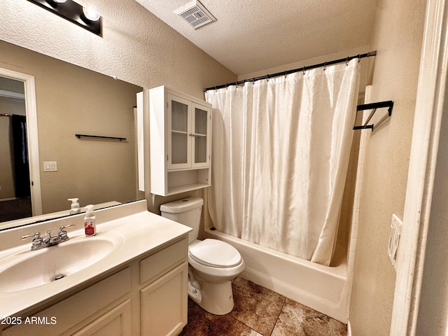 full bathroom with vanity, toilet, a textured ceiling, shower / bath combo with shower curtain, and a textured wall