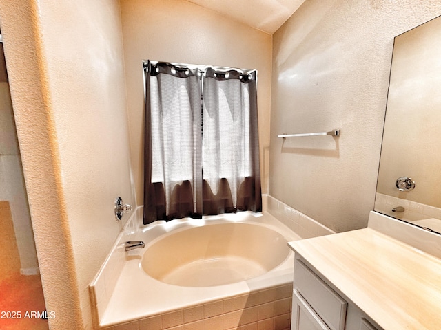 full bathroom featuring a bath and vanity