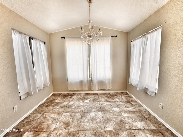 unfurnished room with a chandelier, vaulted ceiling, and baseboards