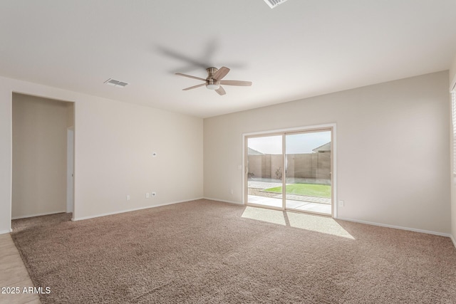 carpeted empty room featuring ceiling fan