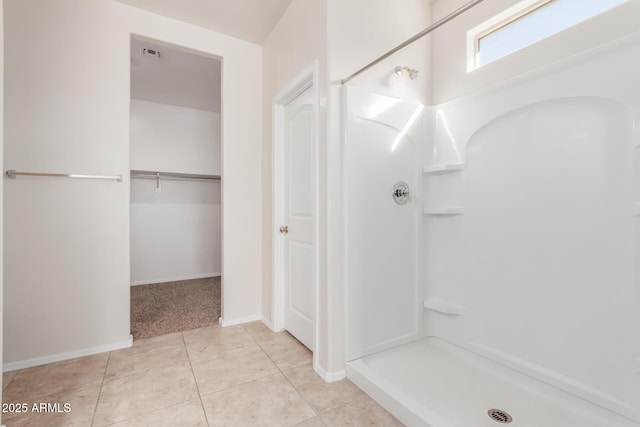 bathroom featuring tile patterned flooring and walk in shower