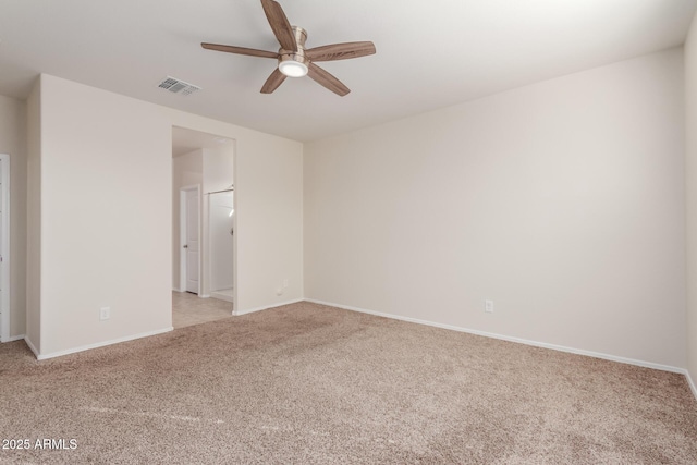 unfurnished room with ceiling fan and light colored carpet