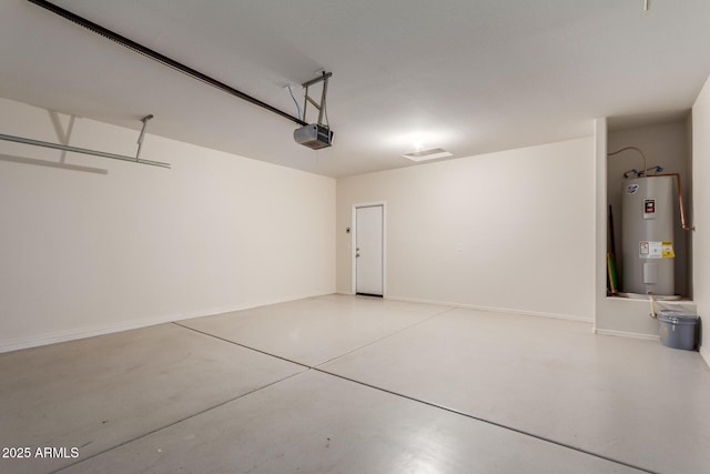 garage featuring electric water heater and a garage door opener