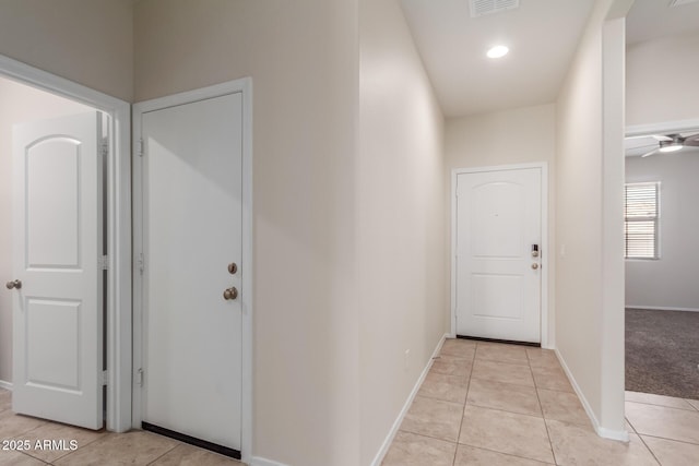 hall with light tile patterned floors