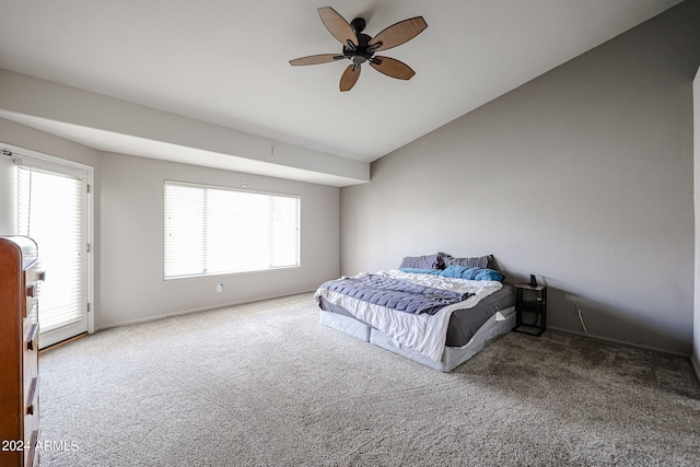 bedroom featuring carpet flooring, ceiling fan, and multiple windows