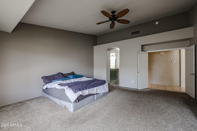 bedroom featuring ceiling fan, ensuite bathroom, and carpet