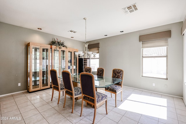 tiled dining room featuring a notable chandelier