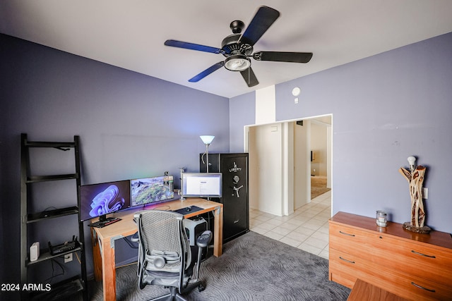 carpeted home office featuring ceiling fan