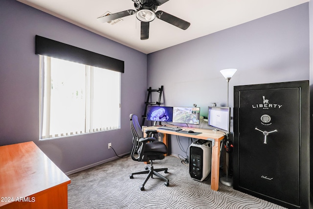 carpeted office space with ceiling fan