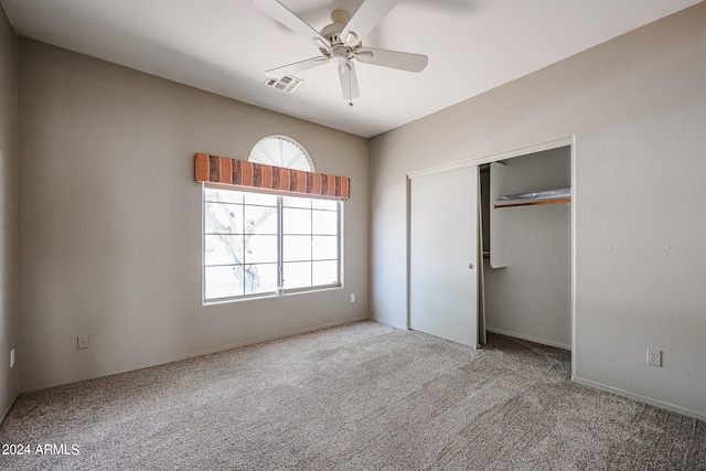 unfurnished bedroom with ceiling fan, a closet, and carpet