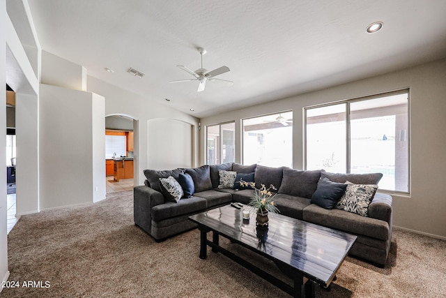 living room featuring light carpet and ceiling fan