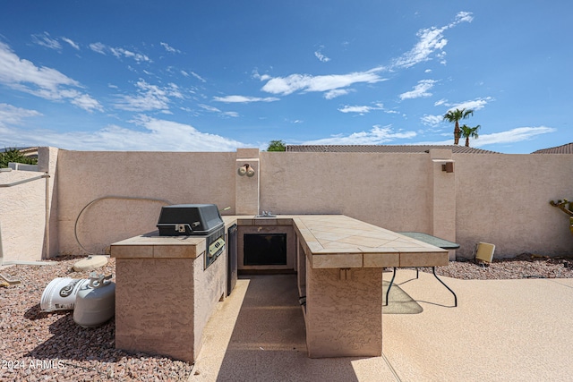 view of patio with exterior kitchen and grilling area