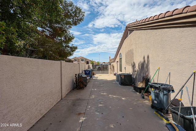 view of side of property featuring a patio and central AC unit