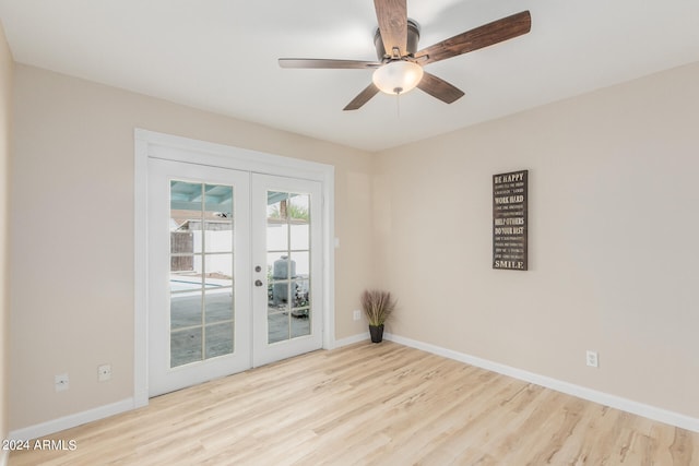 empty room featuring a ceiling fan, light wood-type flooring, french doors, and baseboards