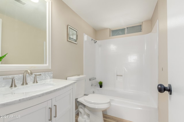 bathroom featuring toilet, vanity, shower / tub combination, and visible vents